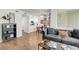 Open-concept living area with modern decor, wood-style floors, and seamless transition to the kitchen and dining area at 7950 W Flamingo Rd # 1042, Las Vegas, NV 89147