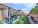 Lush backyard with artificial grass, covered patio seating, and a well-kept garden at 8139 Skytop Ledge Ave, Las Vegas, NV 89178