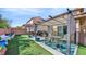 Well-maintained backyard with artificial turf, a covered patio, and a dining area at 8139 Skytop Ledge Ave, Las Vegas, NV 89178