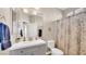Bright bathroom featuring a gray vanity with a modern sink and a decorative shower curtain at 8139 Skytop Ledge Ave, Las Vegas, NV 89178