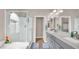 Bright bathroom featuring a walk-in shower, double vanity, and neutral decor at 8139 Skytop Ledge Ave, Las Vegas, NV 89178