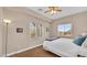 Cozy bedroom with a large window and comfortable bed with throw at 8139 Skytop Ledge Ave, Las Vegas, NV 89178