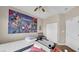 Comfortable bedroom with a large Avengers poster, closet, and neutral color scheme at 8139 Skytop Ledge Ave, Las Vegas, NV 89178