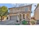 Well-maintained home with a two-car garage, tiled roof, manicured front yard, and an inviting arched entrance at 8139 Skytop Ledge Ave, Las Vegas, NV 89178