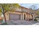 Charming home featuring a two-car garage, well-maintained landscaping, and a welcoming front porch with decorative columns at 8139 Skytop Ledge Ave, Las Vegas, NV 89178