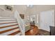 Elegant foyer with wood staircase, wood floors, and natural light streaming in from the windows, creating a warm welcome at 8139 Skytop Ledge Ave, Las Vegas, NV 89178