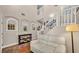Inviting foyer with wood floors, a comfortable sofa, staircase and decor that adds warmth and character to the home at 8139 Skytop Ledge Ave, Las Vegas, NV 89178