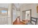 Hallway with wood floors, large mirror, and access to multiple rooms at 8139 Skytop Ledge Ave, Las Vegas, NV 89178