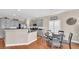 Bright kitchen features gray cabinets, granite countertops, stainless steel appliances, and a cozy breakfast nook at 8139 Skytop Ledge Ave, Las Vegas, NV 89178