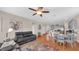 Open-concept living area with wood floors, and an adjacent kitchen, creating a spacious and inviting atmosphere at 8139 Skytop Ledge Ave, Las Vegas, NV 89178