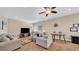 Comfortable living room with neutral walls, ceiling fan, a television, and comfortable furniture at 8139 Skytop Ledge Ave, Las Vegas, NV 89178