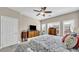 This main bedroom features a ceiling fan, shutters, and dressers for ample storage space at 8139 Skytop Ledge Ave, Las Vegas, NV 89178