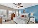 The bright main bedroom features a ceiling fan, shutters, and a calming color scheme at 8139 Skytop Ledge Ave, Las Vegas, NV 89178