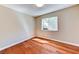 Bedroom with window allowing for natural light and wood floor with white trim at 8729 Pesaro Dr, Las Vegas, NV 89117