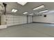 Spacious three car garage with ample lighting and epoxy floor at 8729 Pesaro Dr, Las Vegas, NV 89117