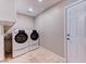Laundry room with front-loading washer and dryer set and exterior door to the right at 8729 Pesaro Dr, Las Vegas, NV 89117