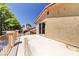Exterior view of the house with a concrete patio, metal fence, stucco walls, and access to the backyard pool at 8729 Pesaro Dr, Las Vegas, NV 89117