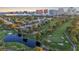 Aerial of a lush green golf course, mature trees and pond with city skyline at 882 Tam O Shanter, Las Vegas, NV 89109