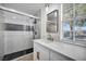 Updated bathroom with glass enclosed shower, modern vanity, stylish mirror, and fixtures at 882 Tam O Shanter, Las Vegas, NV 89109