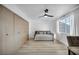 Bright bedroom with large closet, ceiling fan, wood-look floors, and ample natural light at 882 Tam O Shanter, Las Vegas, NV 89109