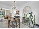 Contemporary dining area with wood table set, stylish furniture, mirror, and modern light fixture at 882 Tam O Shanter, Las Vegas, NV 89109