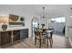 Bright dining area features modern lighting fixture, mirror, stylish furniture, and outdoor access at 882 Tam O Shanter, Las Vegas, NV 89109