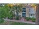 A quaint two-story home with mature landscaping and a charming brick walkway to the front door at 882 Tam O Shanter, Las Vegas, NV 89109