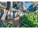 Charming two-story home featuring private balconies, a bench and a tree at 882 Tam O Shanter, Las Vegas, NV 89109