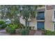 Charming two-story home with a blue door, black railing and a professionally landscaped yard at 882 Tam O Shanter, Las Vegas, NV 89109