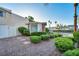 Beautiful home featuring brick landscaping, a white fence and lush green bushes at 882 Tam O Shanter, Las Vegas, NV 89109