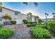 Beautiful home with stone and brick landscaping, a white fence and lush green bushes at 882 Tam O Shanter, Las Vegas, NV 89109