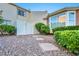 Charming home featuring stone landscaping, a white fence and lush green bushes at 882 Tam O Shanter, Las Vegas, NV 89109