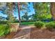 Well-maintained green space with lush grass, mature trees, and a brick pathway at 882 Tam O Shanter, Las Vegas, NV 89109