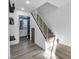 Hallway with vinyl floors, white staircase, and access to an updated bathroom at 882 Tam O Shanter, Las Vegas, NV 89109