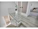 Bright hallway features white railings, gray wood-look floors, and multiple doorways to bedrooms and closets at 882 Tam O Shanter, Las Vegas, NV 89109