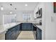 Modern kitchen with white and blue cabinets, marble countertops, and stainless steel appliances at 882 Tam O Shanter, Las Vegas, NV 89109