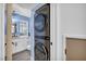 Conveniently stacked, modern, front-load washer and dryer sit beside an updated bathroom at 882 Tam O Shanter, Las Vegas, NV 89109