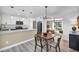 Well-lit open-plan area with a dining table and updated kitchen in the background at 882 Tam O Shanter, Las Vegas, NV 89109