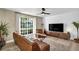 Modern living room features a leather sofa, contemporary furnishings, and a large window at 882 Tam O Shanter, Las Vegas, NV 89109