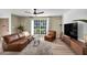 Bright living room with hardwood floors, ceiling fan, and comfortable leather seating at 882 Tam O Shanter, Las Vegas, NV 89109