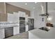 Modern kitchen includes stainless steel appliances and stylish white cabinets for ample storage at 9180 Mohawk St, Las Vegas, NV 89139