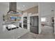 Spacious kitchen with stainless appliances, a large island and opens to the living area at 9180 Mohawk St, Las Vegas, NV 89139