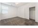 Bright and cozy bedroom with carpeted floors, a large window, and a closet with sliding doors at 9850 Poplar Point Ave, Las Vegas, NV 89178