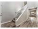 Bright entryway features wood-look flooring that leads to the staircase with white risers and light gray carpet at 9850 Poplar Point Ave, Las Vegas, NV 89178