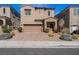 Inviting two-story home features a two-car garage, manicured landscaping, and a covered front porch entry at 9850 Poplar Point Ave, Las Vegas, NV 89178