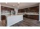 Modern kitchen features dark cabinets, stainless steel appliances, a tile backsplash, and a center island at 9850 Poplar Point Ave, Las Vegas, NV 89178