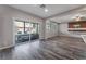 Bright living room features wood-look floors, a sliding glass door, and a modern media console at 9850 Poplar Point Ave, Las Vegas, NV 89178