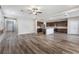 Open-concept living room and kitchen showcases stylish wood-look floors, modern light fixtures, and neutral paint at 9850 Poplar Point Ave, Las Vegas, NV 89178