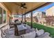 Inviting covered patio with comfortable seating, a fire pit, and manicured landscaping at 9850 Poplar Point Ave, Las Vegas, NV 89178