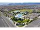 Aerial view of a community with a pool, recreation center, playground, and open green spaces at 10160 Tree Blossom Ave, Las Vegas, NV 89166